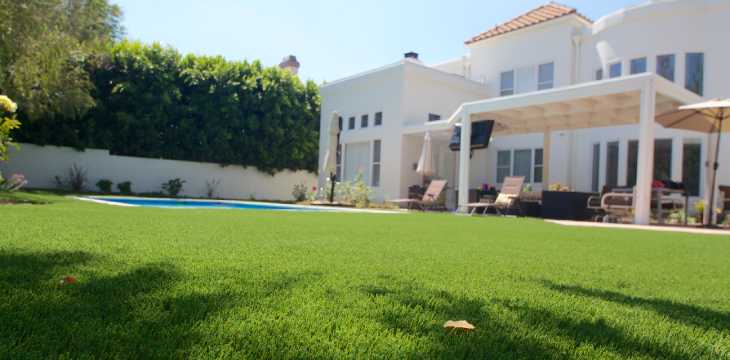 Artificial grass backyard with pool installed by SYNLawn