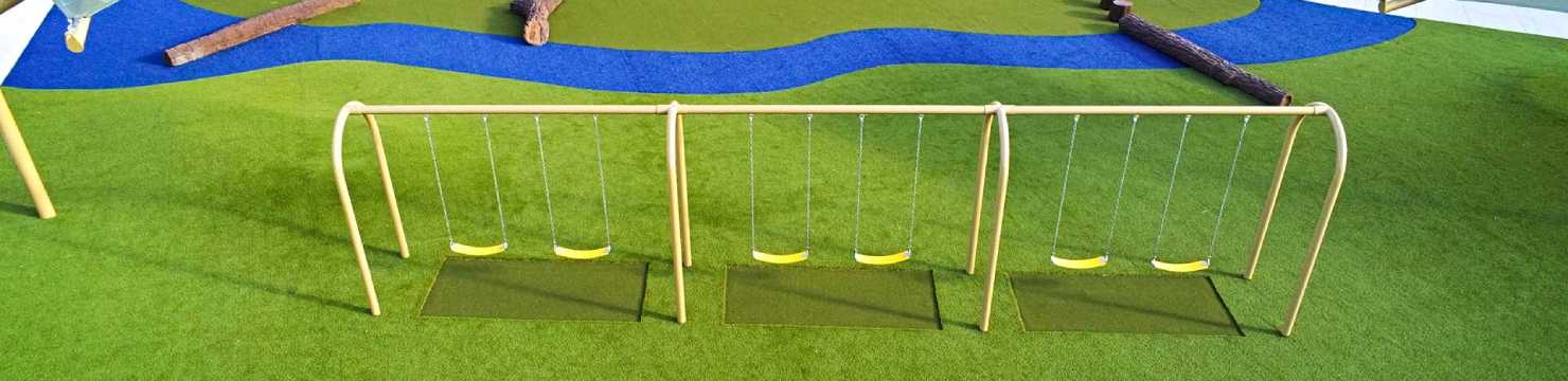 Swing set installed on artificial grass